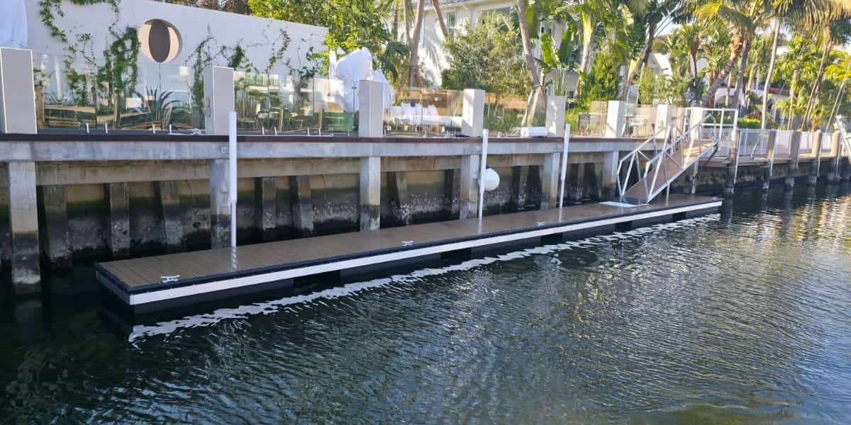waterfront floating dock with synthetic surface showing best decking for docks in a coastal residential setting