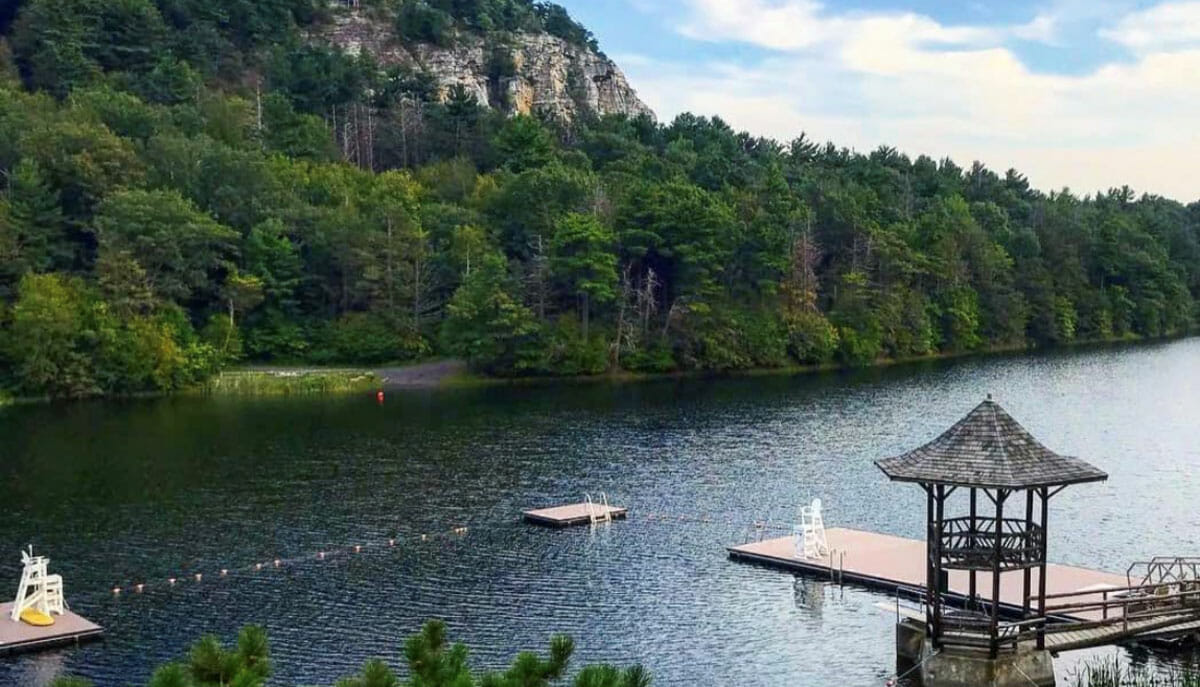 Floating Fishing Pier with a gazebo that is over a lake