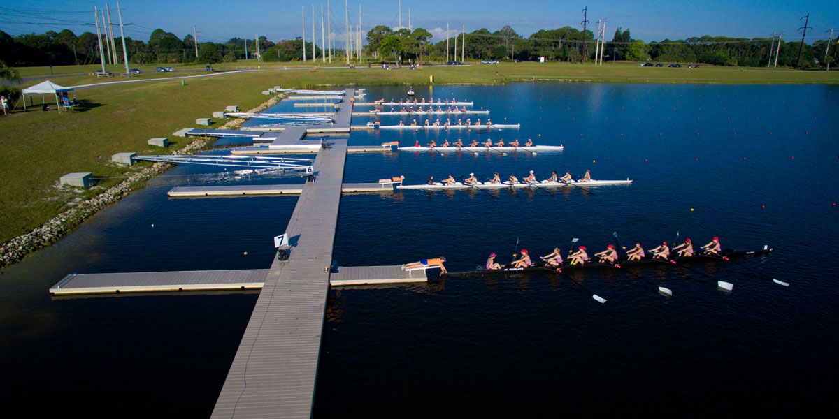 Six rowing teams are launching off floating docks used for elite rowing facilities.